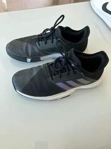 Adidas Gamecourt tennis shoes, black mesh upper with white EVA midsole.