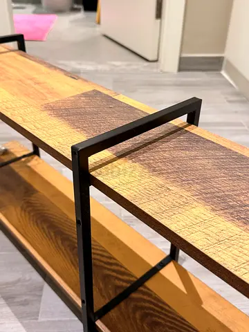 Industrial-style wooden shelving unit with black metal frame