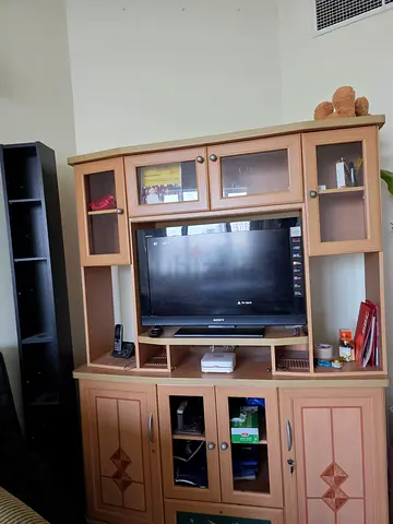 Wooden entertainment center with cabinets and shelves - good condition