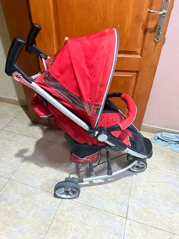 Red lightweight baby stroller in good used condition