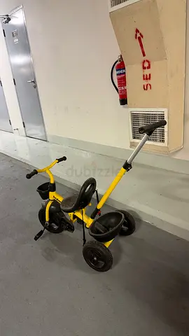 Yellow toddler tricycle with parent push handle - good used condition