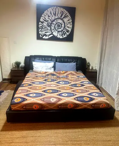 A beautiful black Leather King Bed with a brand new mattress