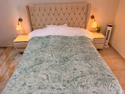 Queen bed with tufted headboard and two bedside tables