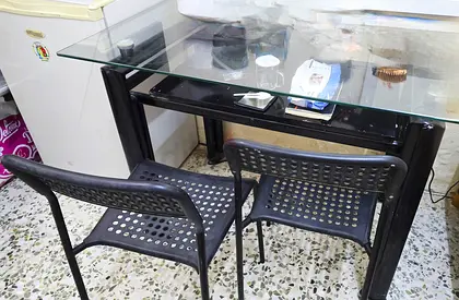 Glass Top dining table wonderful condition with two chair just 100AED