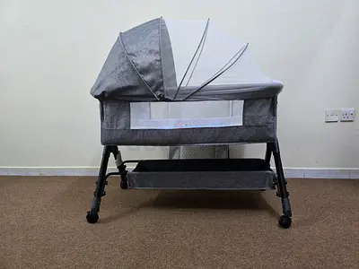 Grey Bassinet/Cradle with Changing Pad and Storage Shelves