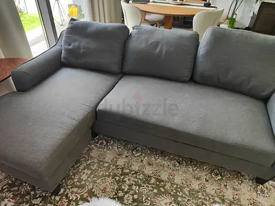 L-shaped grey sleeper couch sofa