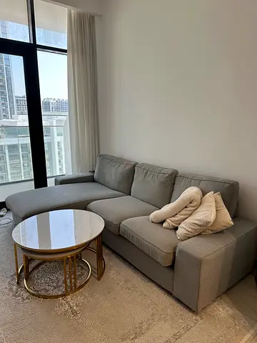 Light grey L-shaped fabric sofa with matching bed chair