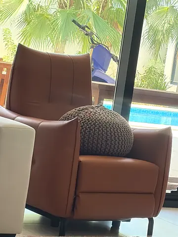 Brown leather armchair with matching ottoman - good condition