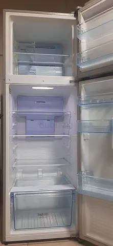 Used double-door refrigerator with freezer - spacious interior, clean condition