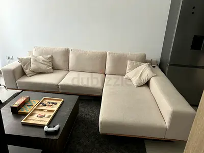 Beige L-shaped 4-seater Sofa with Wooden Base - Good Condition