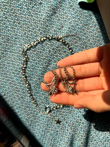 Silver-tone star charm layered necklace and earring set with crystal accents