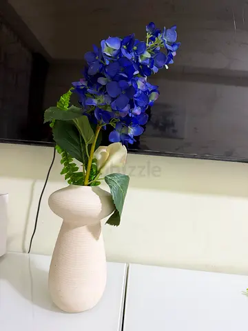 Ceramic decorative vase with artificial blue hydrangea bouquet