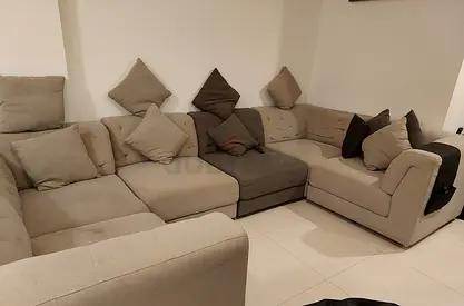 Light and dark grey sectional sofa with cushions