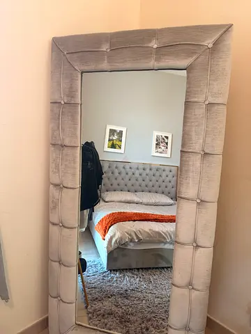 Padded standing mirror
