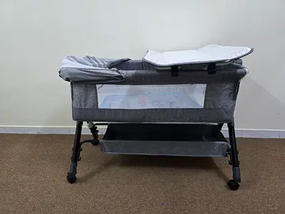 Grey Bassinet/Cradle with Changing Pad and Storage Shelves