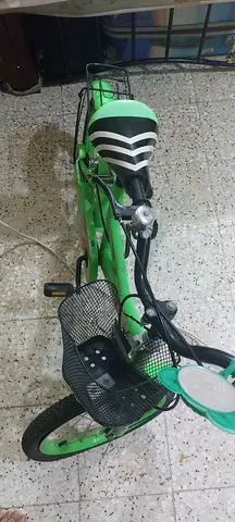 Green kids bicycle with basket  wear and tare and rear rack — used, good condition