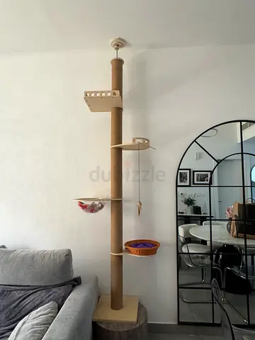 Tall ceiling-to-floor cat scratching post with perches and basket