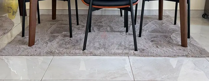 Gray textured area rug, used under dining table - good condition