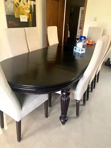 Solid Dark Wood Dining Table with 8 Upholstered Chairs. table is expandable