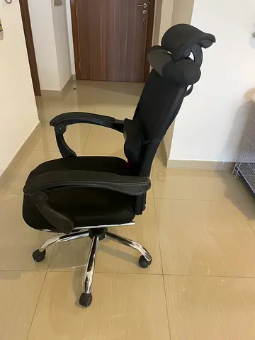 Ergonomic black office chair with headrest and lumbar support