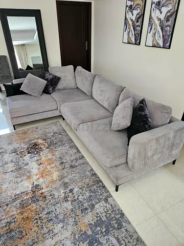 Light grey L-shaped fabric sofa with chaise