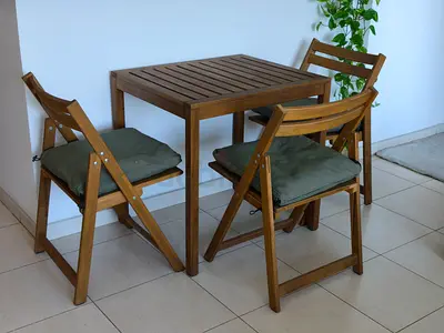 Ikea Solid Wood almost brand new Table + 3 foldable Chairs with green cushions