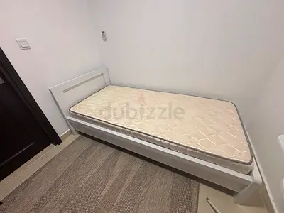 Single white wooden bed frame with mattress - excellent condition. 90x200cm. With wardrobe 400 AED.