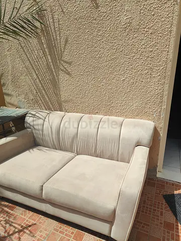 2-seater beige fabric sofa in good condition