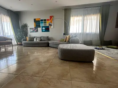 Large curved grey modular sofa with ottoman - modern living room set