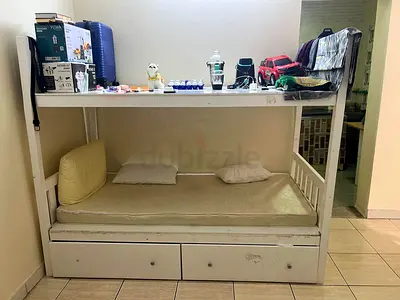 White wooden bunk-style daybed with storage drawers