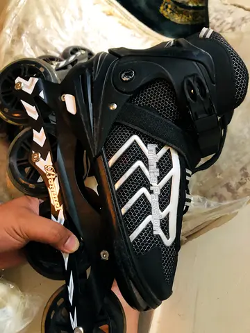 Used black inline rollerblades, adjustable fit