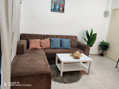 L-shaped Brown Sofa with Coffee Table - Good Condition