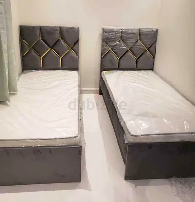Brand New Pair of grey velvet single beds with storage and tufted gold-accented headboards