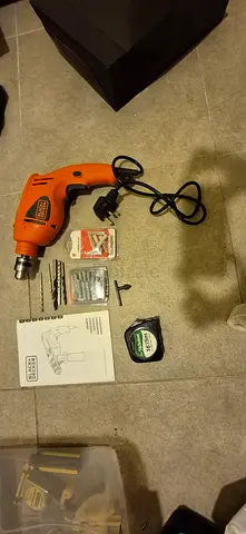 Black  Decker corded electric drill with bits and accessories