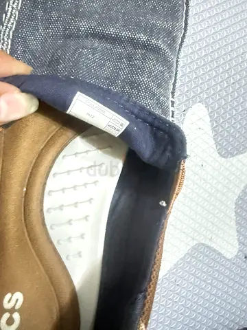 Used casual slip-on shoes, size visible inside