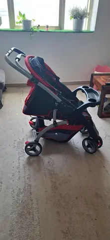 Lightweight red and black baby stroller, good condition