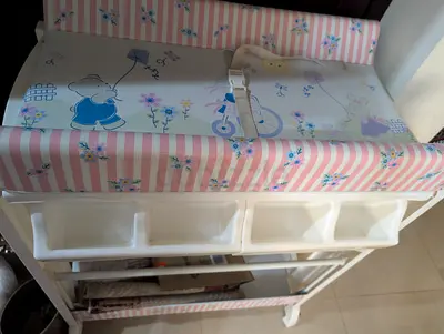 Used baby changing table with storage and padded changing mat