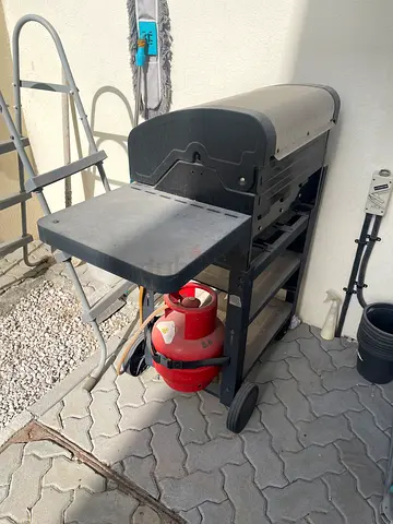 Used propane gas BBQ grill with side table and wheels