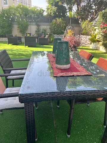 6-Seater Wicker Outdoor Dining Table with Glass Top and Cushioned Chairs