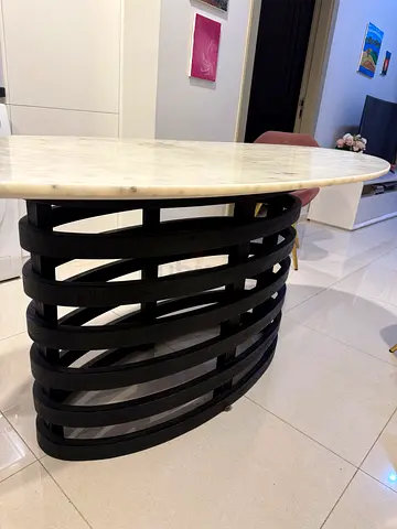 Round marble-top coffee table with black slatted base