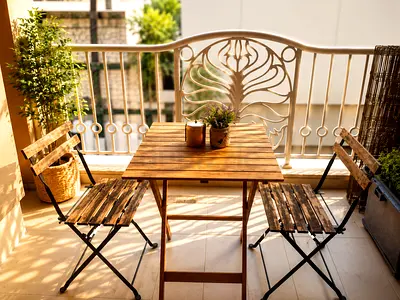 Wooden bistro table with two folding chairs - compact balcony set