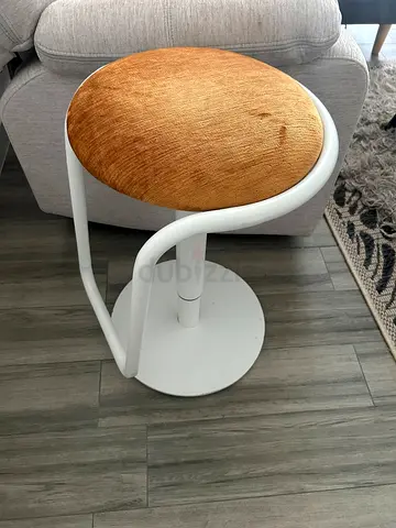 Modern white metal swivel stool with orange velvet seat