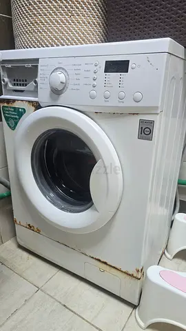 Used front-load washing machine — working, some rust on casing