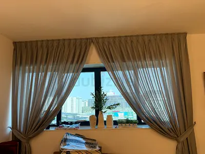 Light grey floor-length curtains with tiebacks - set of panels