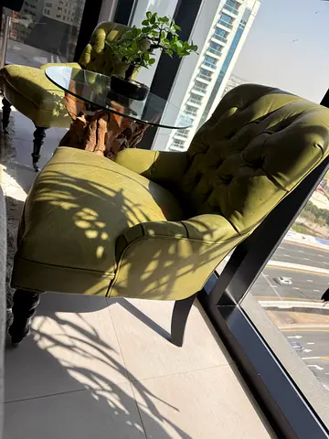 Pair of olive green tufted accent chairs
