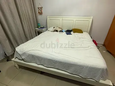 White wooden double bed (king size), Spring Mattress(Wear and Tear),Wall Mirror, White bedside cabin