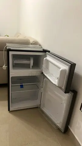 Compact single-door mini fridge with small freezer compartment - good condition