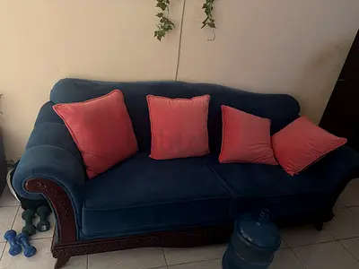 Blue velvet 3-seater sofa with wooden carved frame and cushions