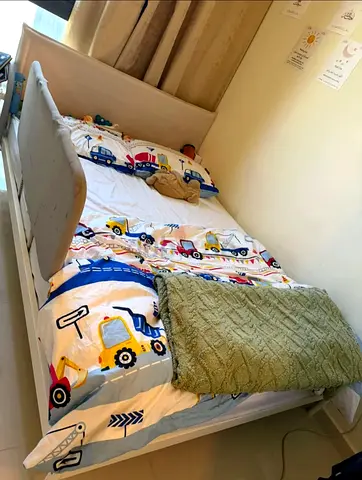 Single Toddler Bed with Safety Rails and Truck-Themed Bedding