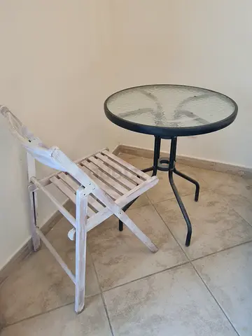 Round Glass Top Bistro Table and Folding Wooden Chair